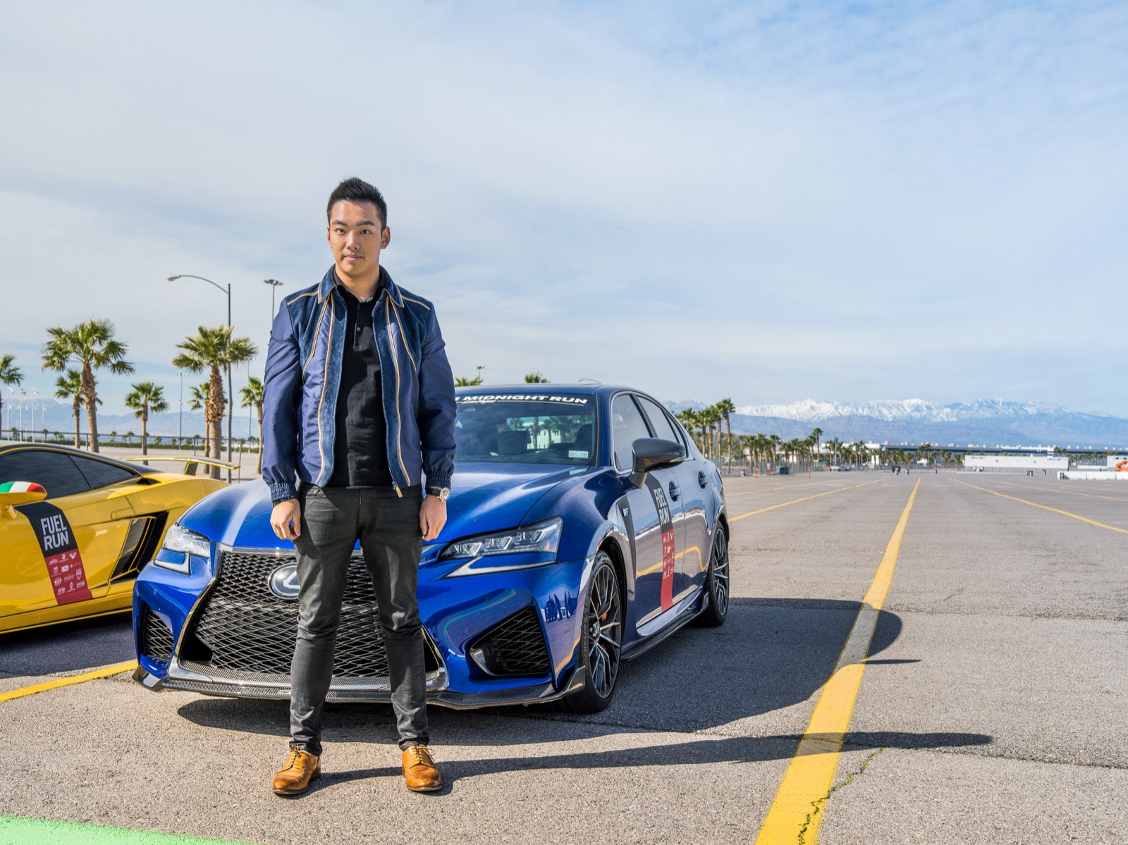 Chadwick standing in front of a blue Lexus at a motorsport event